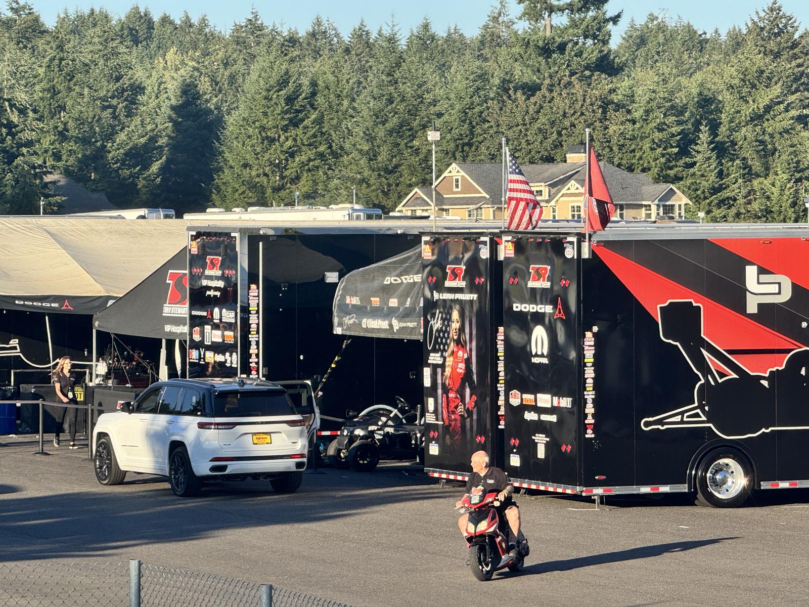 The Tony Stewart Racing haulers and VIP hospitality tent in the paddock at the NHRA Northwest Nationals, with a Rairdon vehicle parked alongside