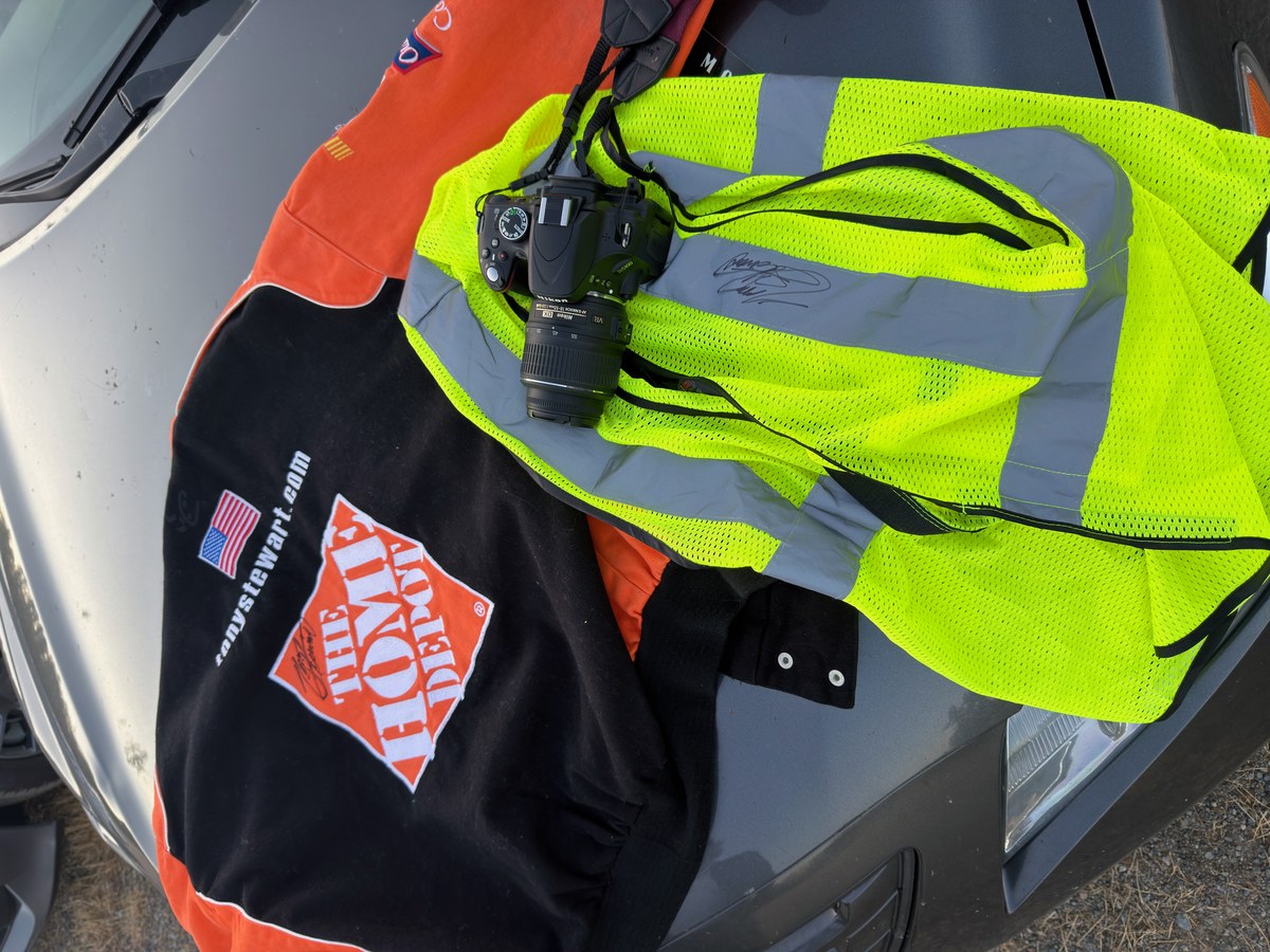 Stasia Smith’s hi-vis crew vest signed by Tony Stewart, laid beside her signed Tony Stewart Racing jacket.