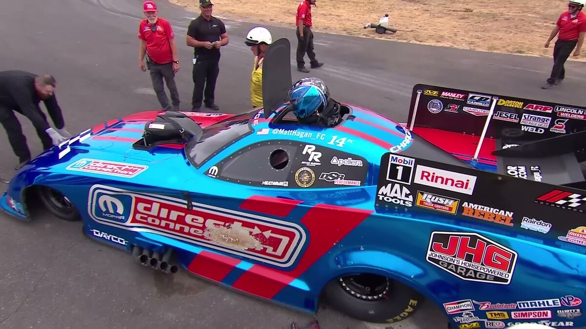 FOX broadcast frame of Matt Hagan's Funny Car with the crew